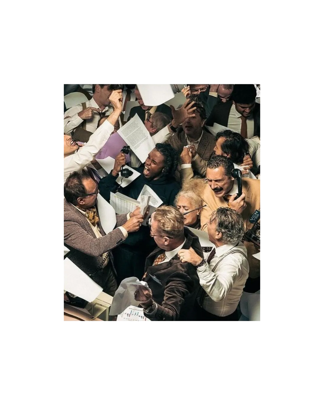 Overhead shot of a trading floor with papers flying